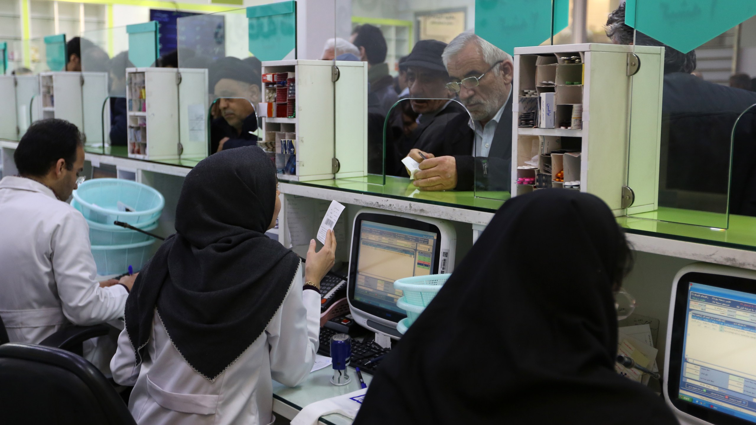 Iranians wait to get prescription drugs at the state-run "13 Aban" pharmacy in Tehran on Feb. 19, 2020. (ATTA KENARE/AFP via Getty Images)