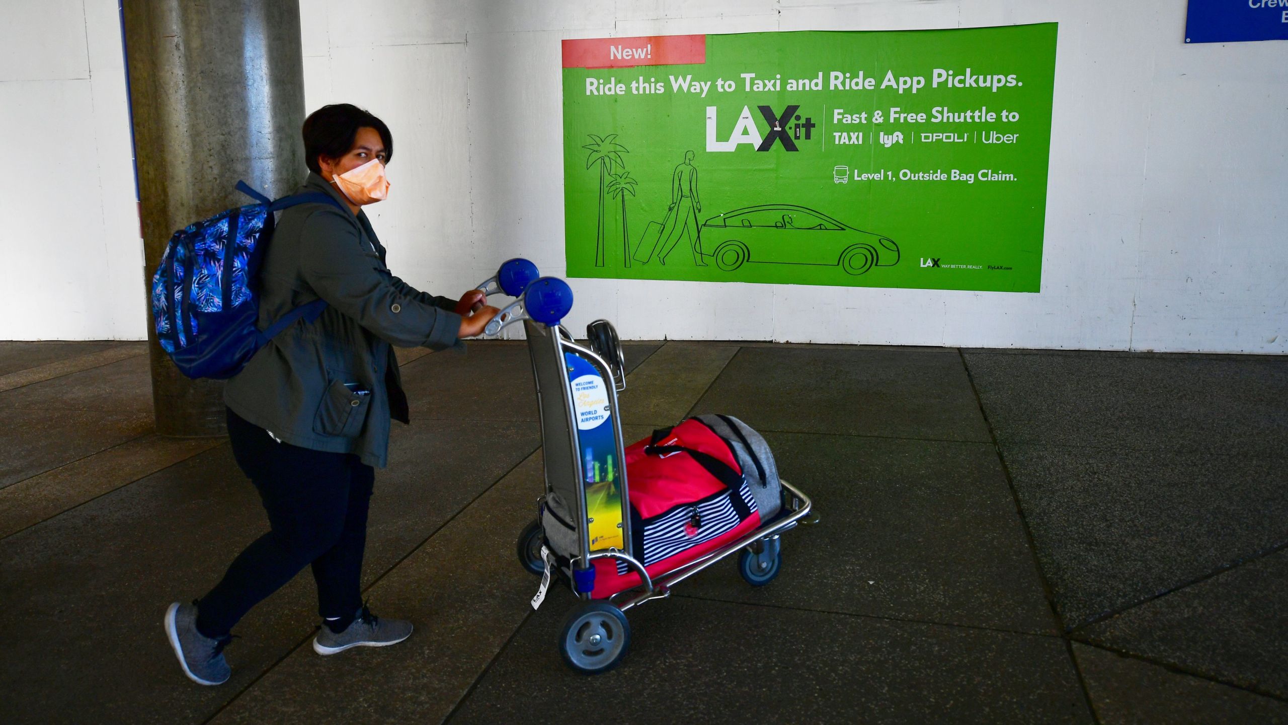 A woman wears a face mask at Los Angeles International Airport on March 2, 2020. (FREDERIC J. BROWN/AFP via Getty Images)