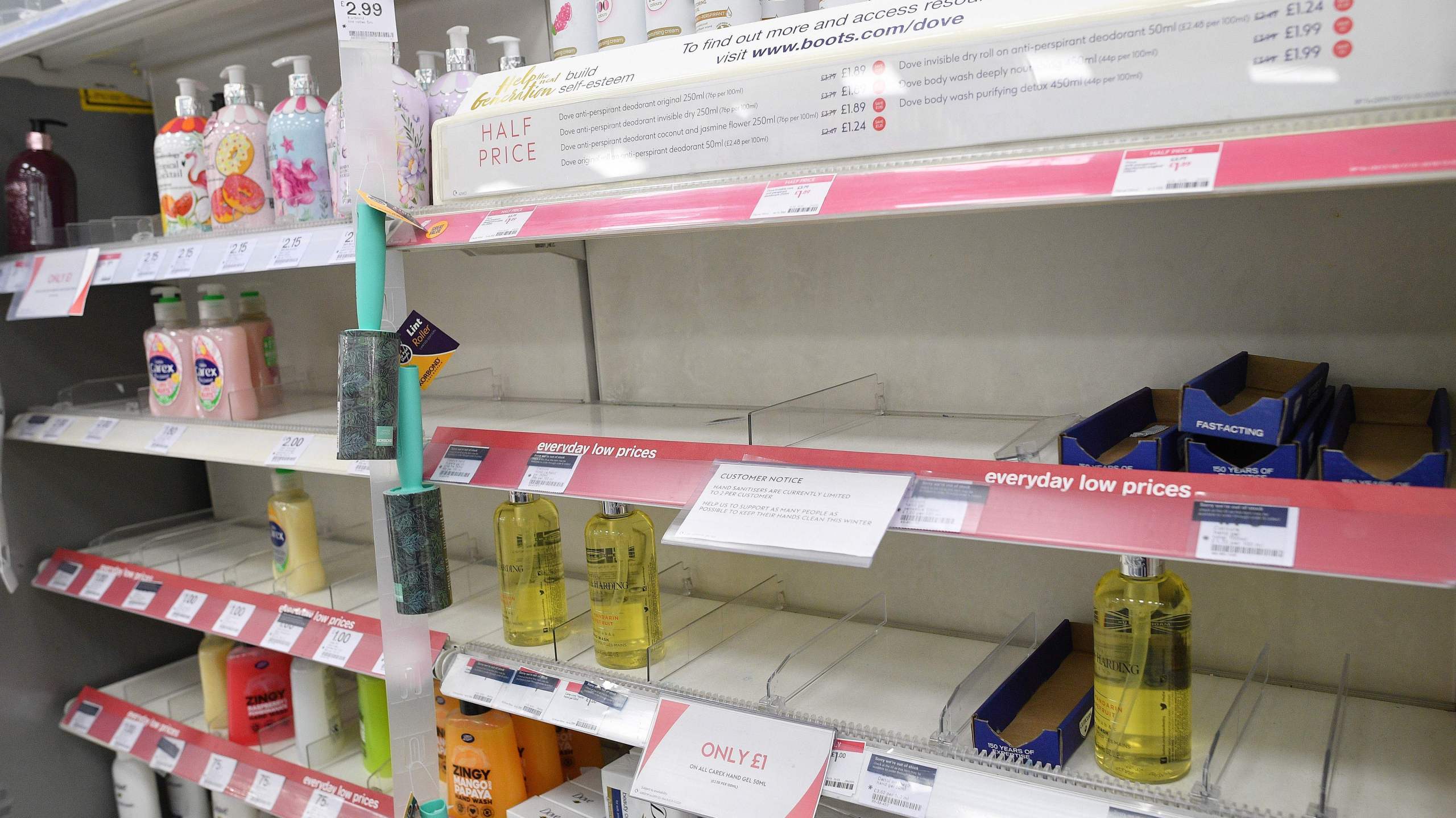 A picture shows a sign, on empty shelves, alerting customers to limited sales of antibacterial hand washes and sanitizer gels, inside a Boots store in London on March 3, 2020. (JUSTIN TALLIS/AFP via Getty Images)