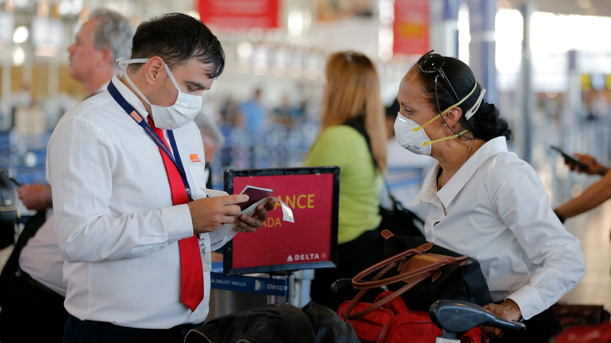 An airline staff member wears a protective mask while working at the Arturo Merino Benitez International Airport, in Santiago, on March 3, 2020.(Javier Torres/AFP via Getty Images)