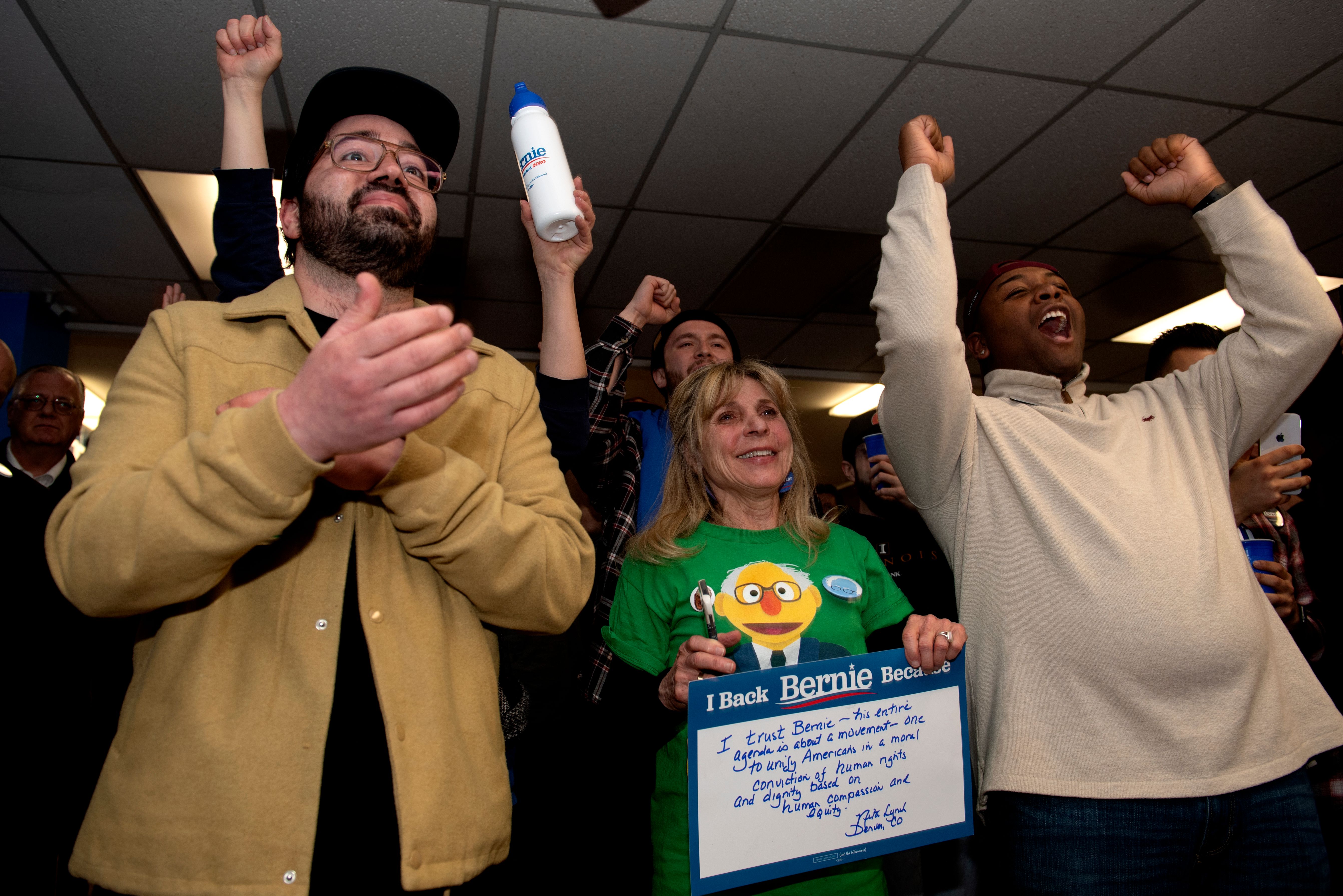 Supporters cheer as they watch a televised address from Democratic presidential candidate Vermont Sen. Bernie Sanders on Super Tuesday, March 3, 2020, in Denver, Colorado.(JASON CONNOLLY/AFP via Getty Images)