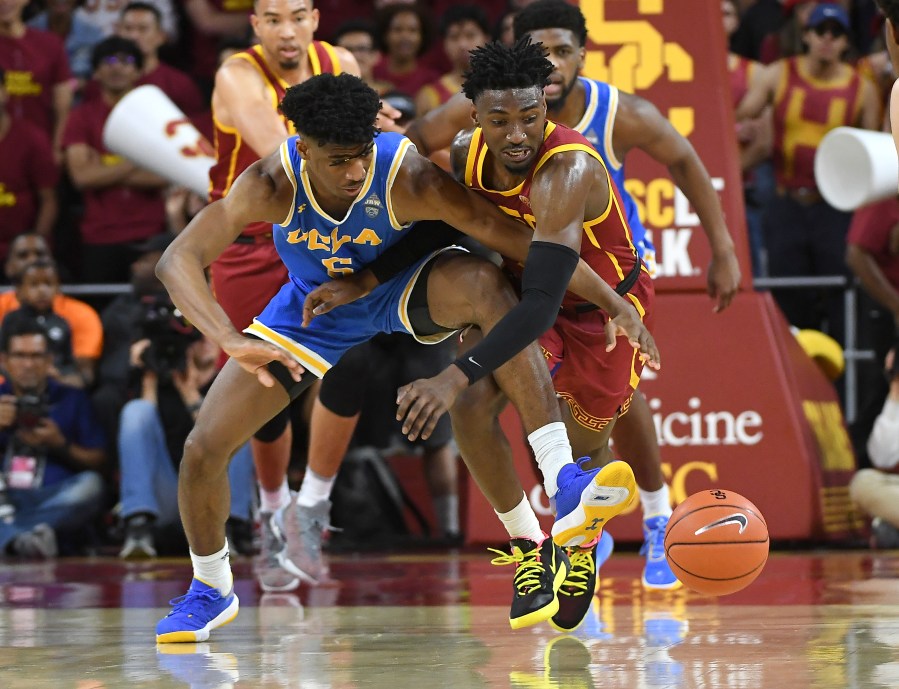 Chris Smith #5 of the UCLA Bruins and Jonah Mathews #2 of the USC Trojans battle for a loose ball in the second half of the game at Galen Center on March 7, 2020. (Jayne Kamin-Oncea/Getty Images)