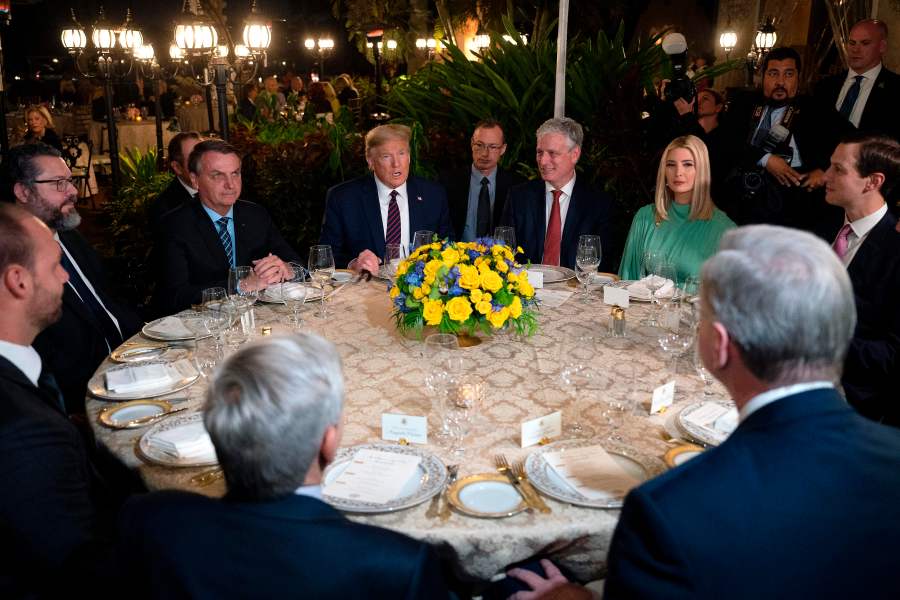 President Donald Trump (C) speaks with Brazilian President Jair Bolsonaro (L), alongside United States National Security Advisor Robert O'Brien (3rd R), Advisor to the President Ivanka Trump (2nd R) and Senior Advisor Jared Kushner (R), during a diner at Mar-a-Lago in Palm Beach, Florida, on March 7, 2020. (JIM WATSON/AFP via Getty Images)