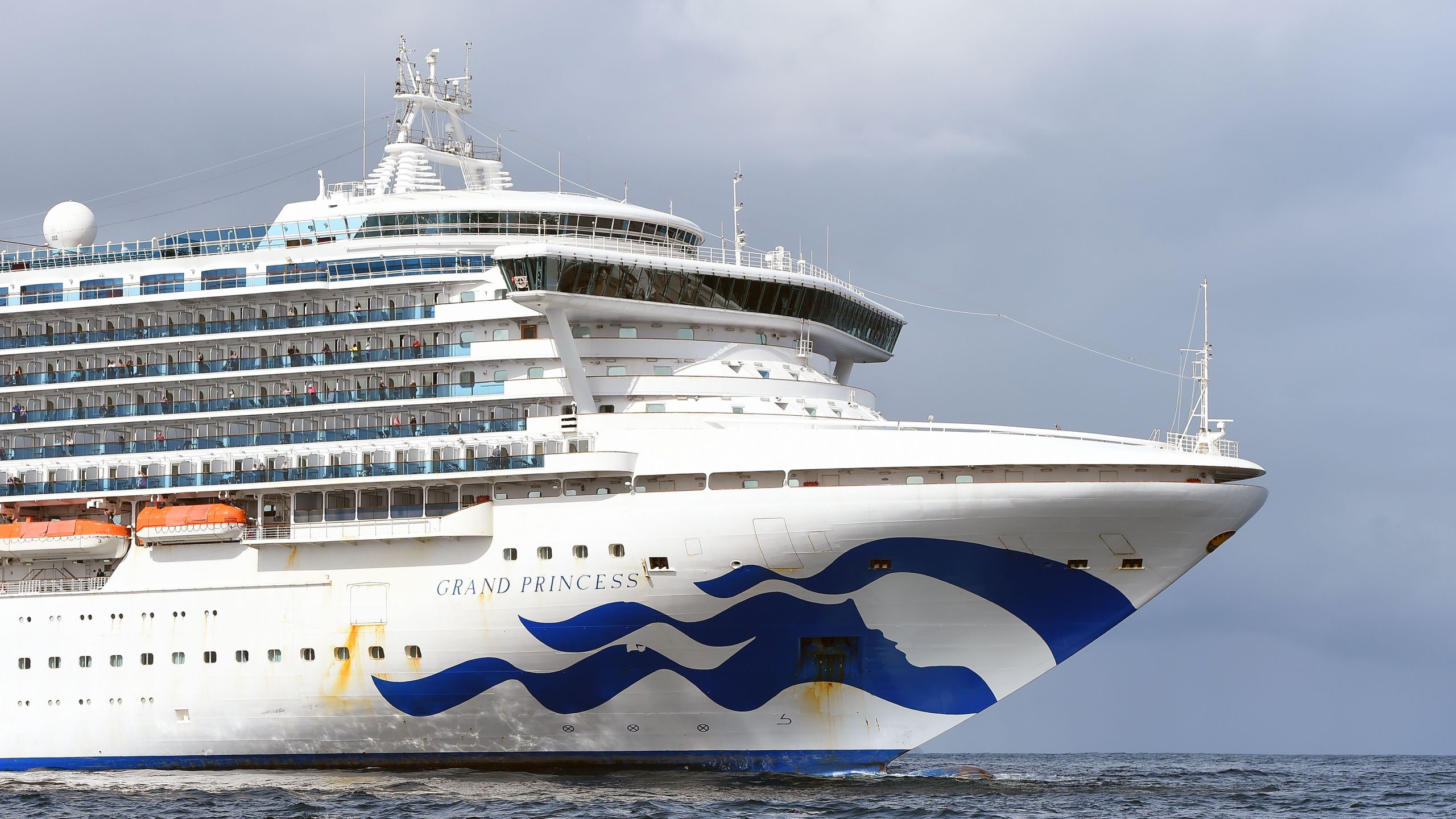 People look out from aboard the Grand Princess cruise ship, operated by Princess Cruises, as it maintains a holding pattern about 25 miles off the coast of San Francisco, California on March 8, 2020. (JOSH EDELSON/AFP via Getty Images)