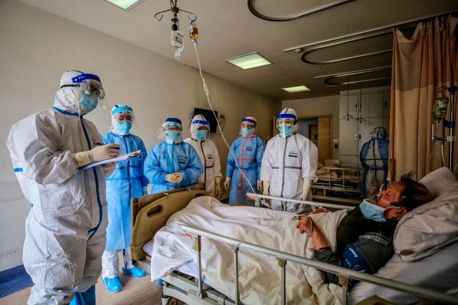 Medical staff speak with a COVID-19 patient at Red Cross Hospital in Wuhan, China, on March 10, 2020. (STR/AFP via Getty Images)