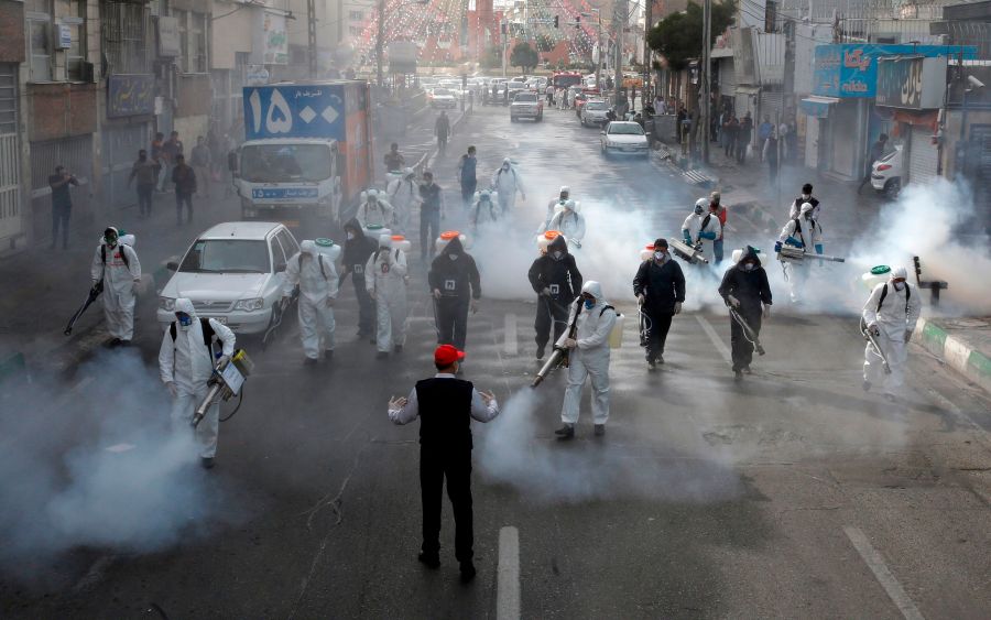 Iranian Firefighters disinfect streets in the capital Tehran in a bid to halt the wild spread of coronavirus on March 13 2020.(AFP via Getty Images)