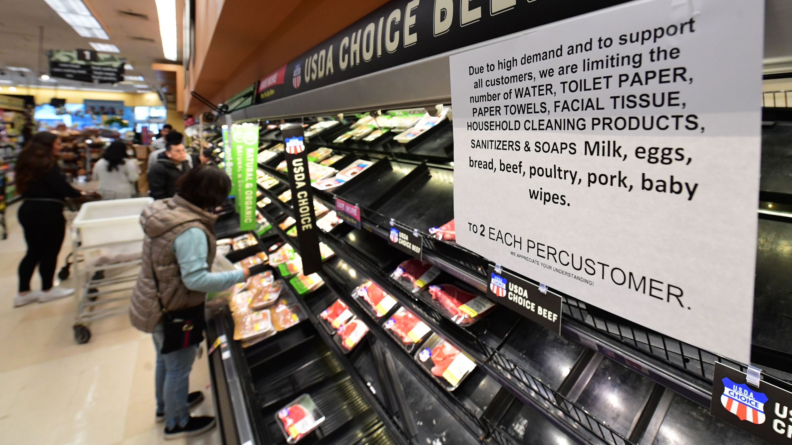 A sign announces a two-item limit for certain items as people shop for food at a Ralph's Supermarket in Monterey Park, Calif. on March 16, 2020, as the Coronavirus pandemic brings much of California to a standstill. (FREDERIC J. BROWN/AFP via Getty Images)