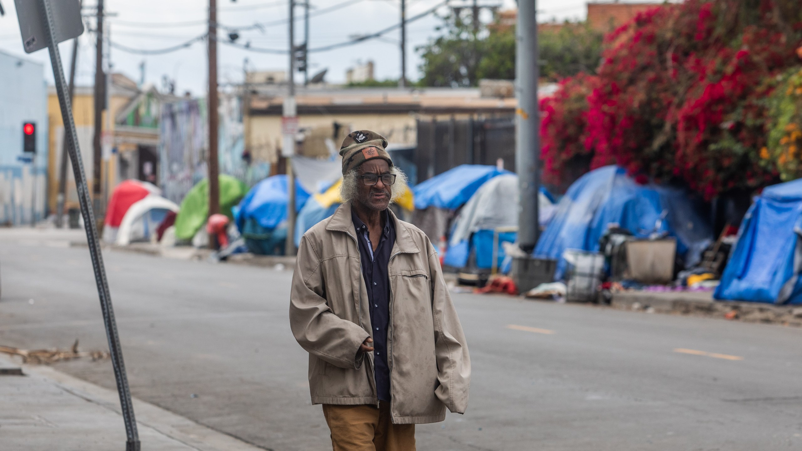 A homeless person walks on San Julian Street in the Skid Row area in downtown Los Angeles on March 19, 2020. (APU GOMES/AFP via Getty Images)