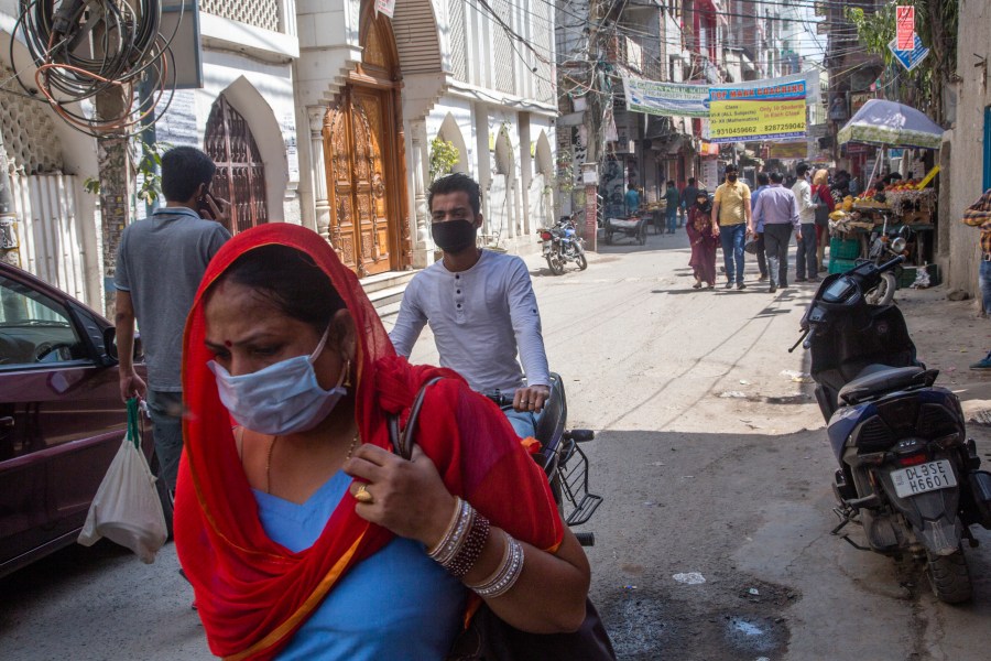 People buy essential commodities in a market amid a lockdown order by Delhi's government as a preventive measure against the COVID-19 on March 23, 2020 in New Delhi, India. (Yawar Nazir/Getty Images)