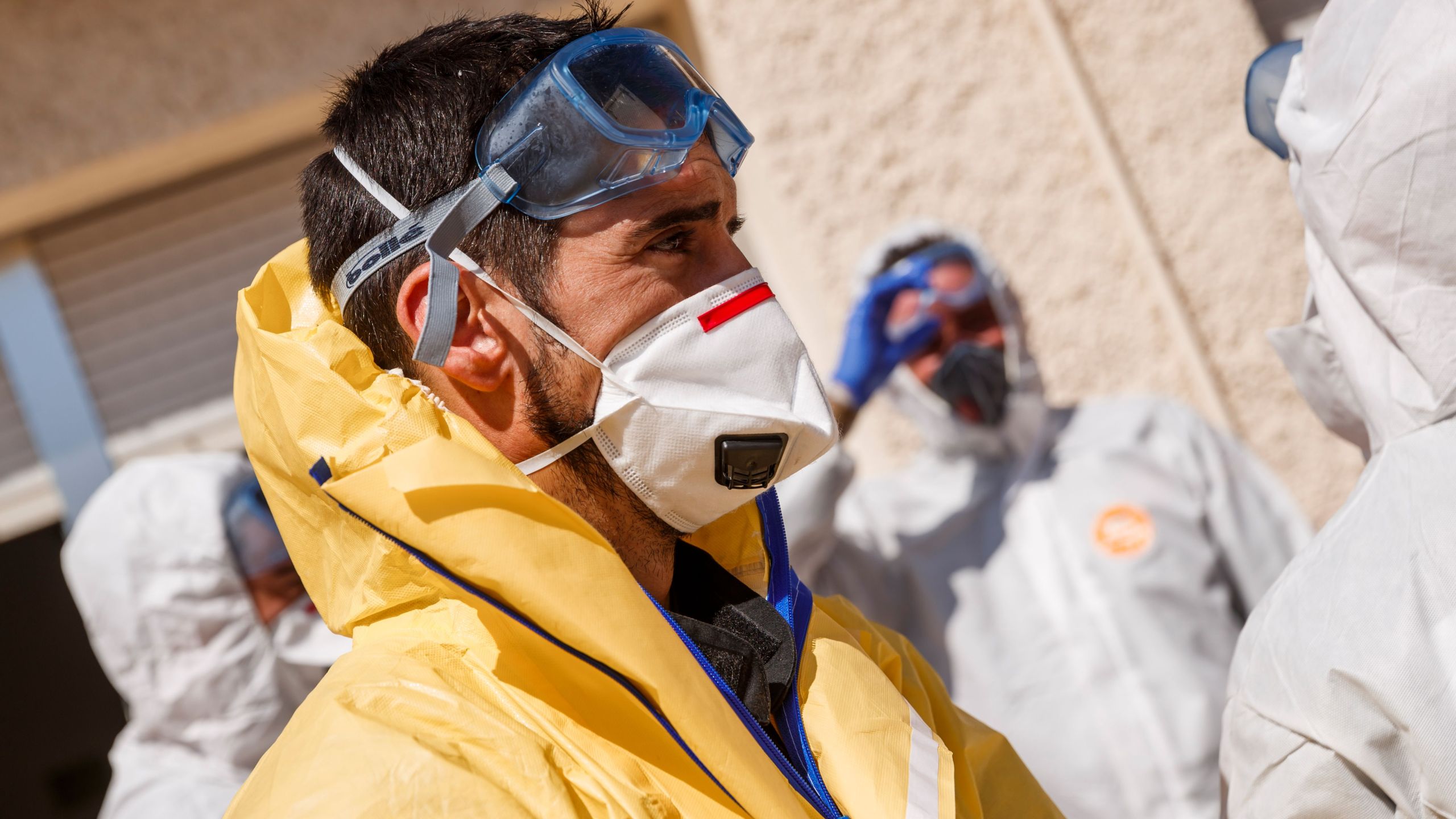 Members of the Military Emergencies Unit (UME) carry out a general disinfection at the Apanid residence for people with physical and intellectual disabilities of all ages in the Getafe suburb of Madrid on March 25, 2020, amid a national lockdown to fight the spread of the COVID-19 coronavirus. (BALDESCA SAMPER/AFP via Getty Images)