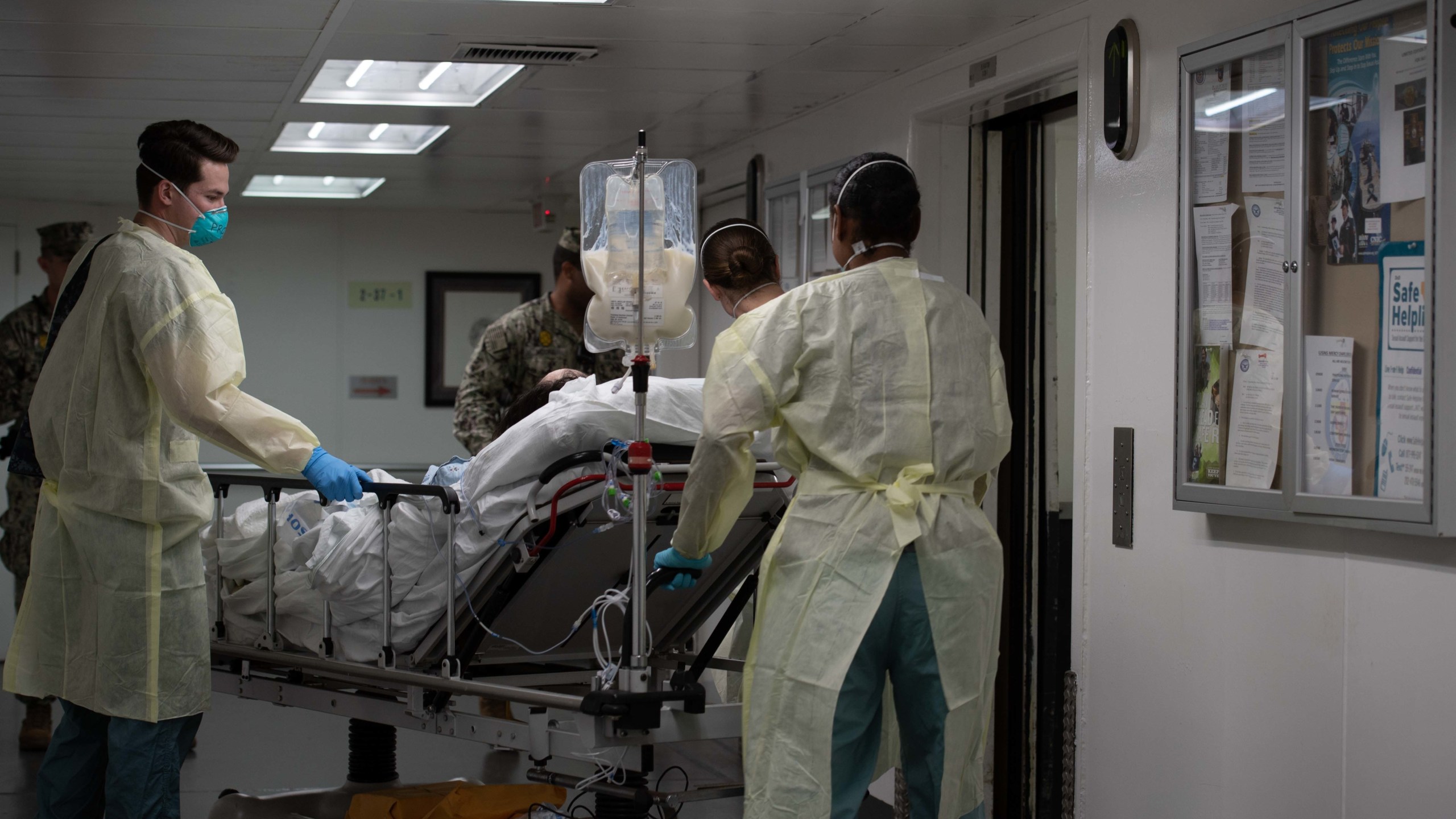 In this handout released by the U.S. Navy, Sailors assigned to the hospital ship USNS Mercy transport the first patient from Los Angeles medical facilities March 29, 2020. Mercy was deployed in support of the nation's COVID-19 response efforts, and will serve as a referral hospital for non-COVID-19 patients currently admitted to shore-based hospitals. This allows other hospitals to focus their efforts on COVID-19 cases. (U.S. Navy via Getty Images)