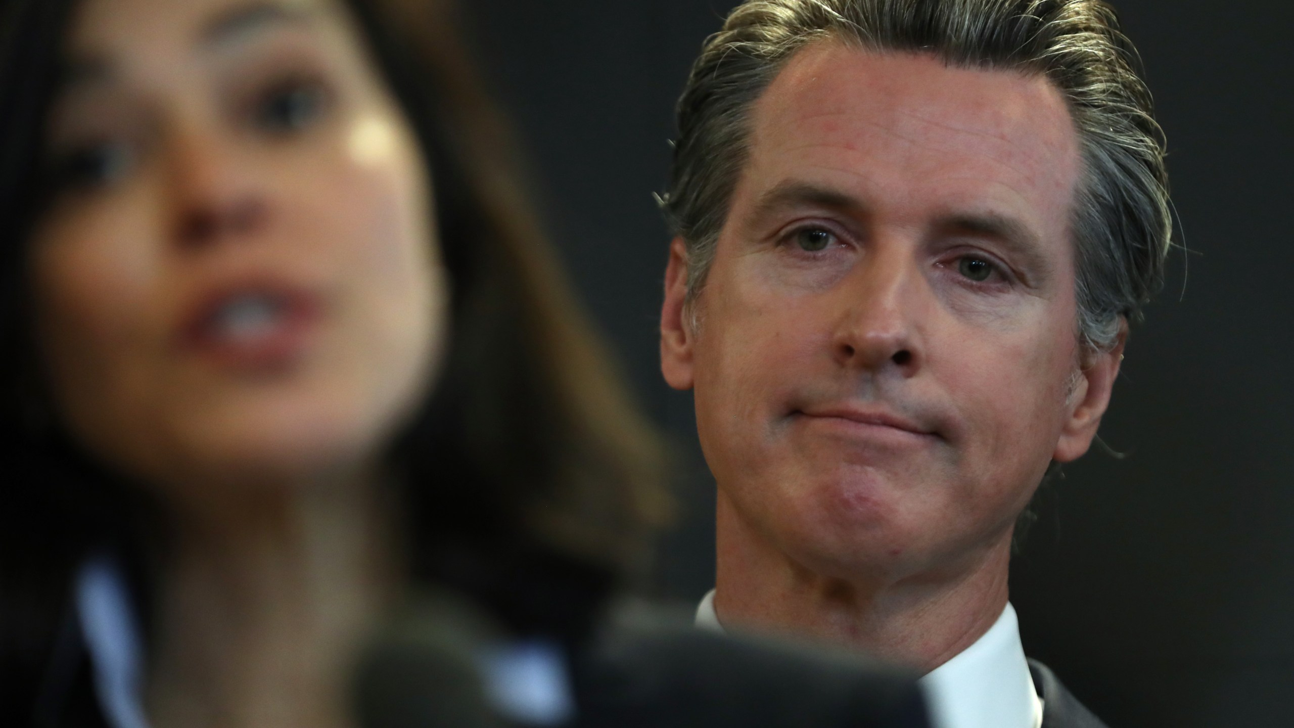 California Gov. Gavin Newsom looks on as California Department of Public Health Director Dr. Sonia Angell speaks during a news conference in Sacramento on Feb. 27, 2020. (Credit: Justin Sullivan / Getty Images)