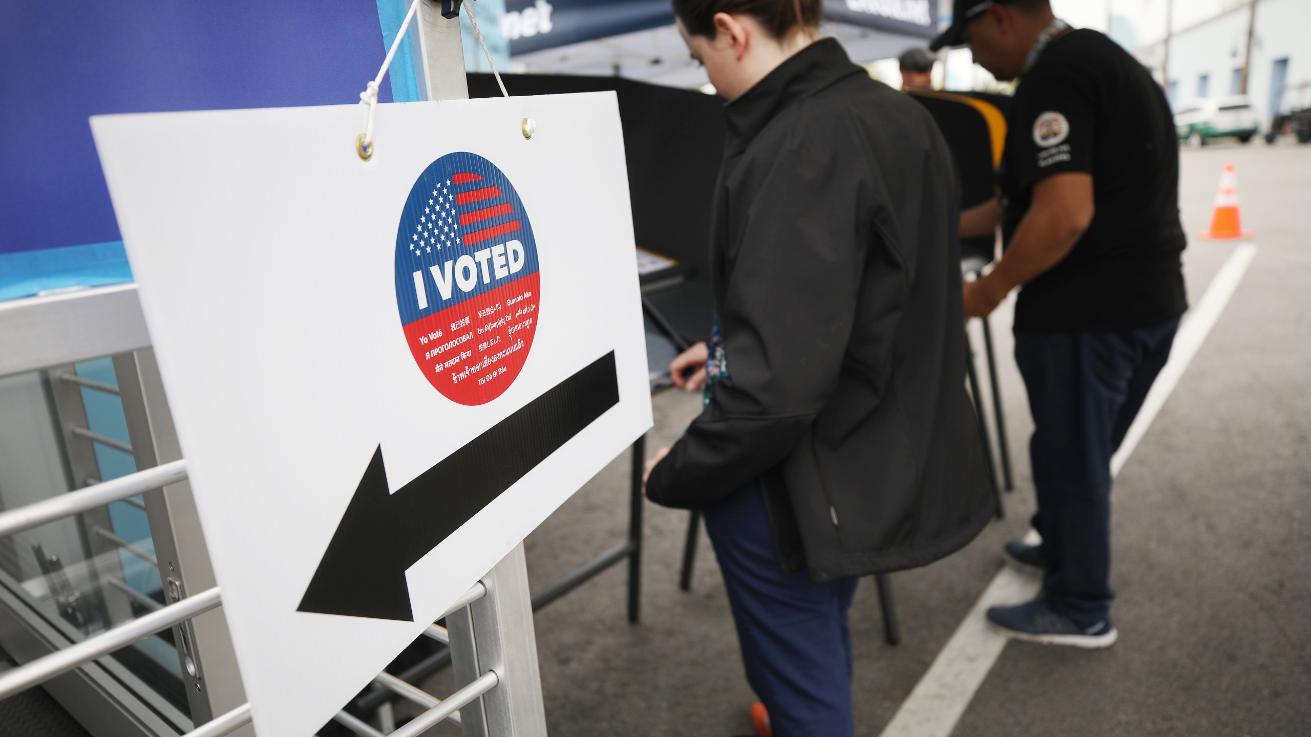 Voters prepare their ballots during early voting for the California presidential primary election outside Universal Studios Hollywood on Feb. 27, 2020. (Credit: Mario Tama / Getty Images)