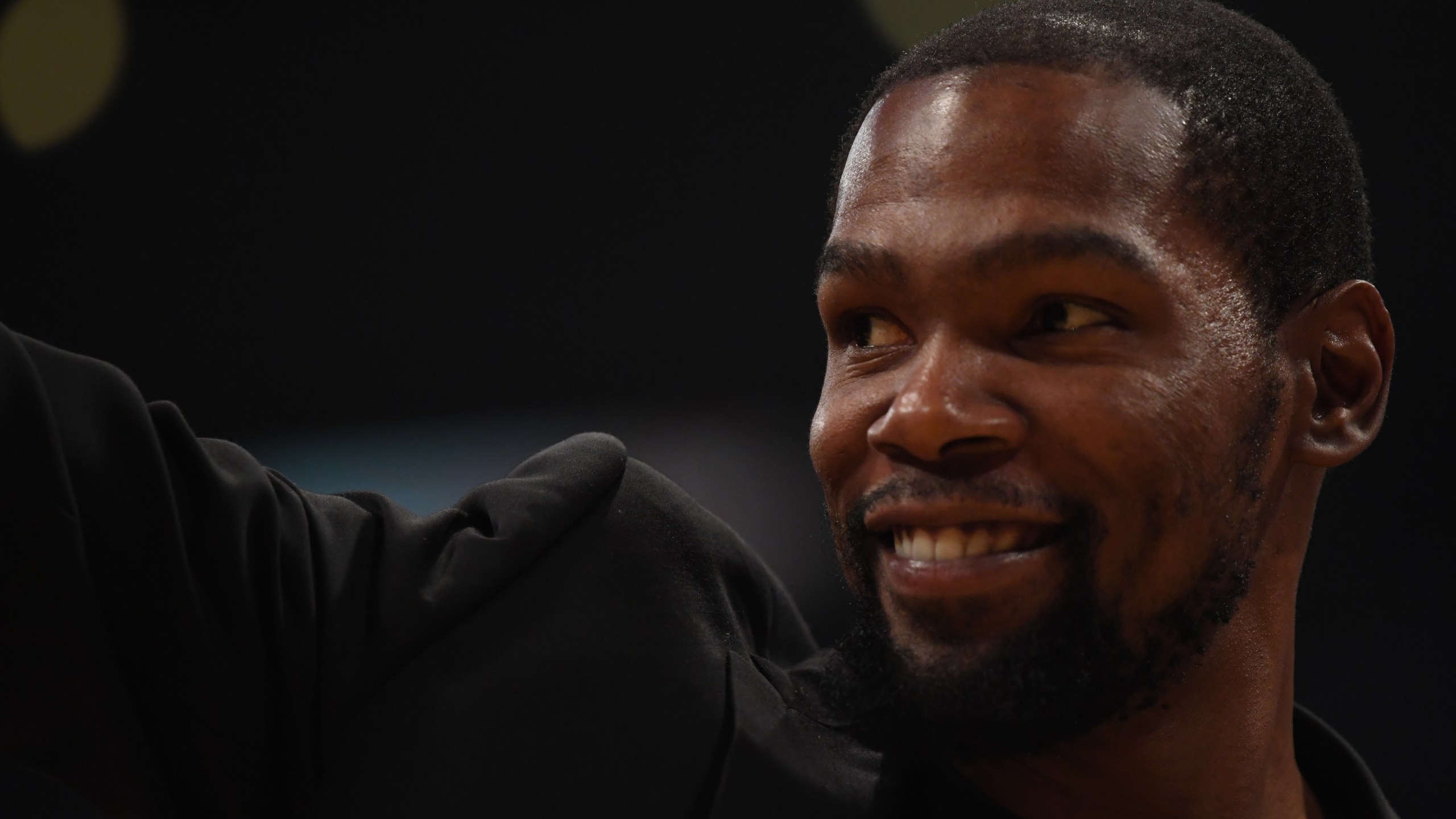 Kevin Durant of the Brooklyn Nets, sidelined by injury, smiles during a game against the Los Angeles Lakers at Staples Center on March 10, 2020. (Credit: Harry How / Getty Images)