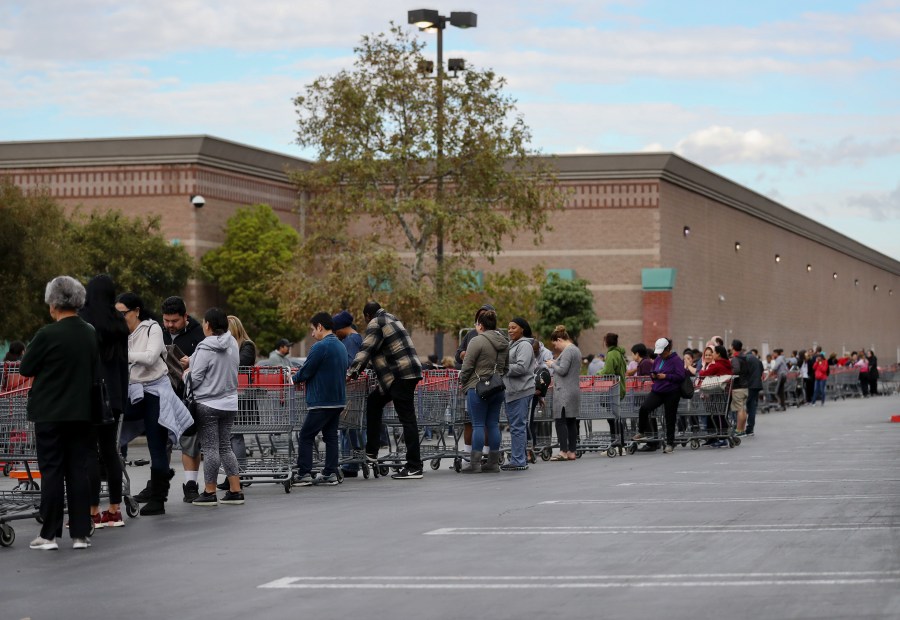 People wait in line to enter a Costco Wholesale store before it opened in the morning on March 12, 2020 in Glendale. (Mario Tama/Getty Images)