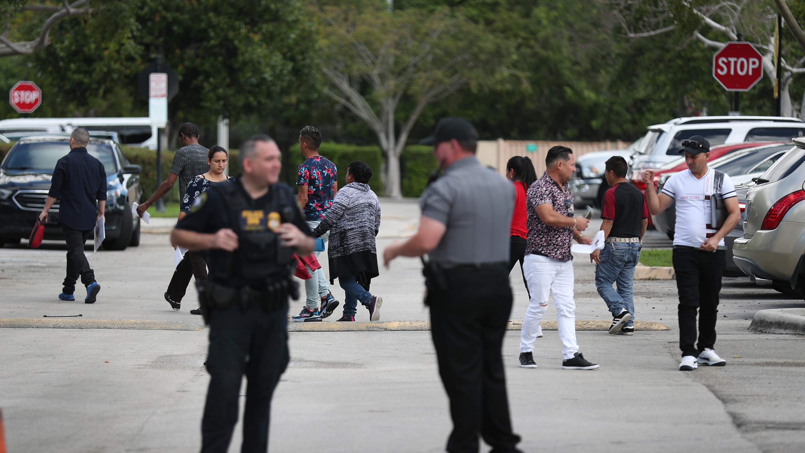 People walk through the parking lot outside the U.S. Immigration and Customs Enforcement office in Miramar, Florida, on March 13, 2020. (Credit: Joe Raedle / Getty Images)