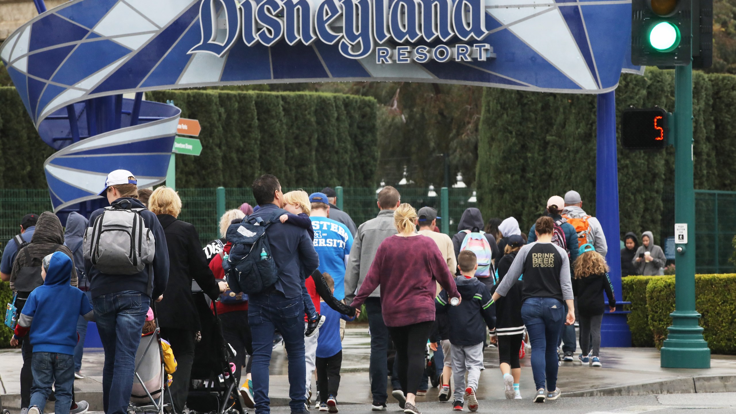 Disneyland visitors enter the famed amusement park in Anaheim on March 13, 2020. (Credit: Mario Tama / Getty Images)