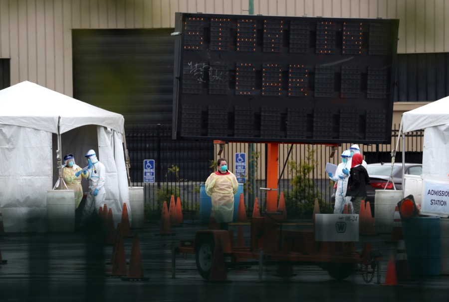 Medical personnel set up a coronavirus drive-thru test clinic at the San Mateo County Event Center on March 16, 2020 in San Mateo. (Justin Sullivan/Getty Images)