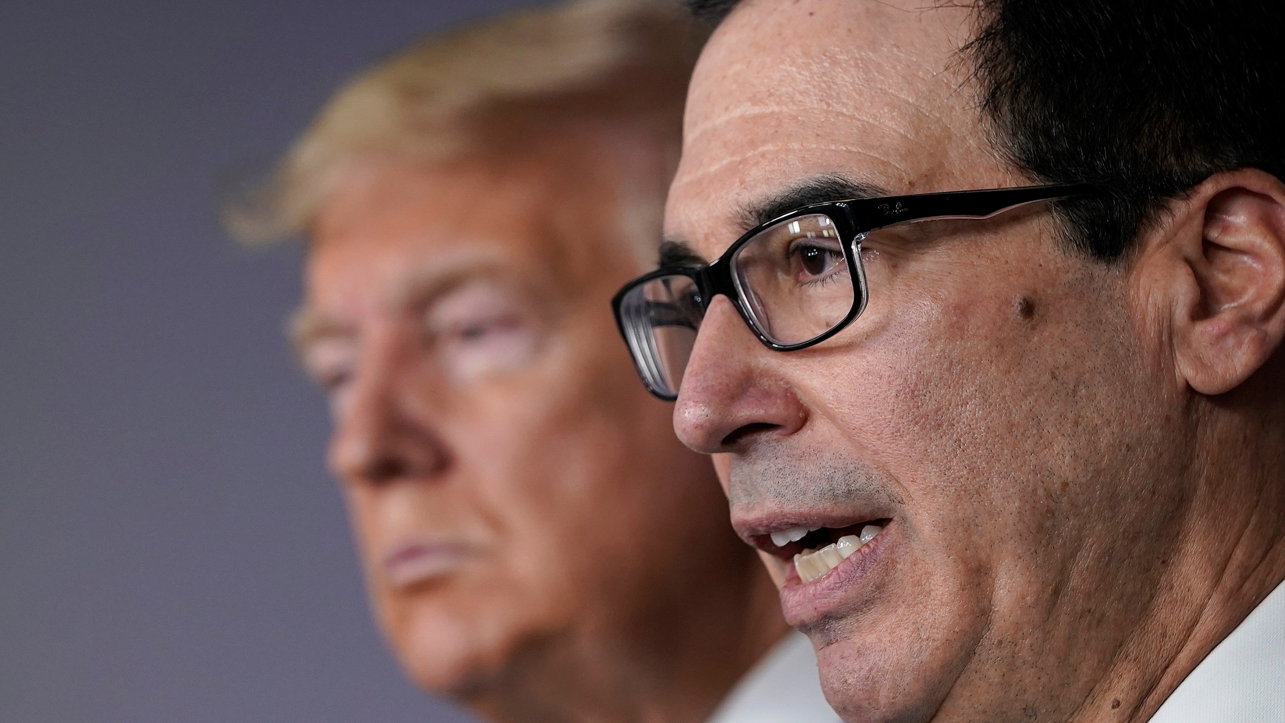 Treasury Secretary Steven Mnuchin (R) speaks while flanked by President Donald Trump during a briefing about the coronavirus in the press briefing room at the White House on March 17, 2020. (Drew Angerer/Getty Images)