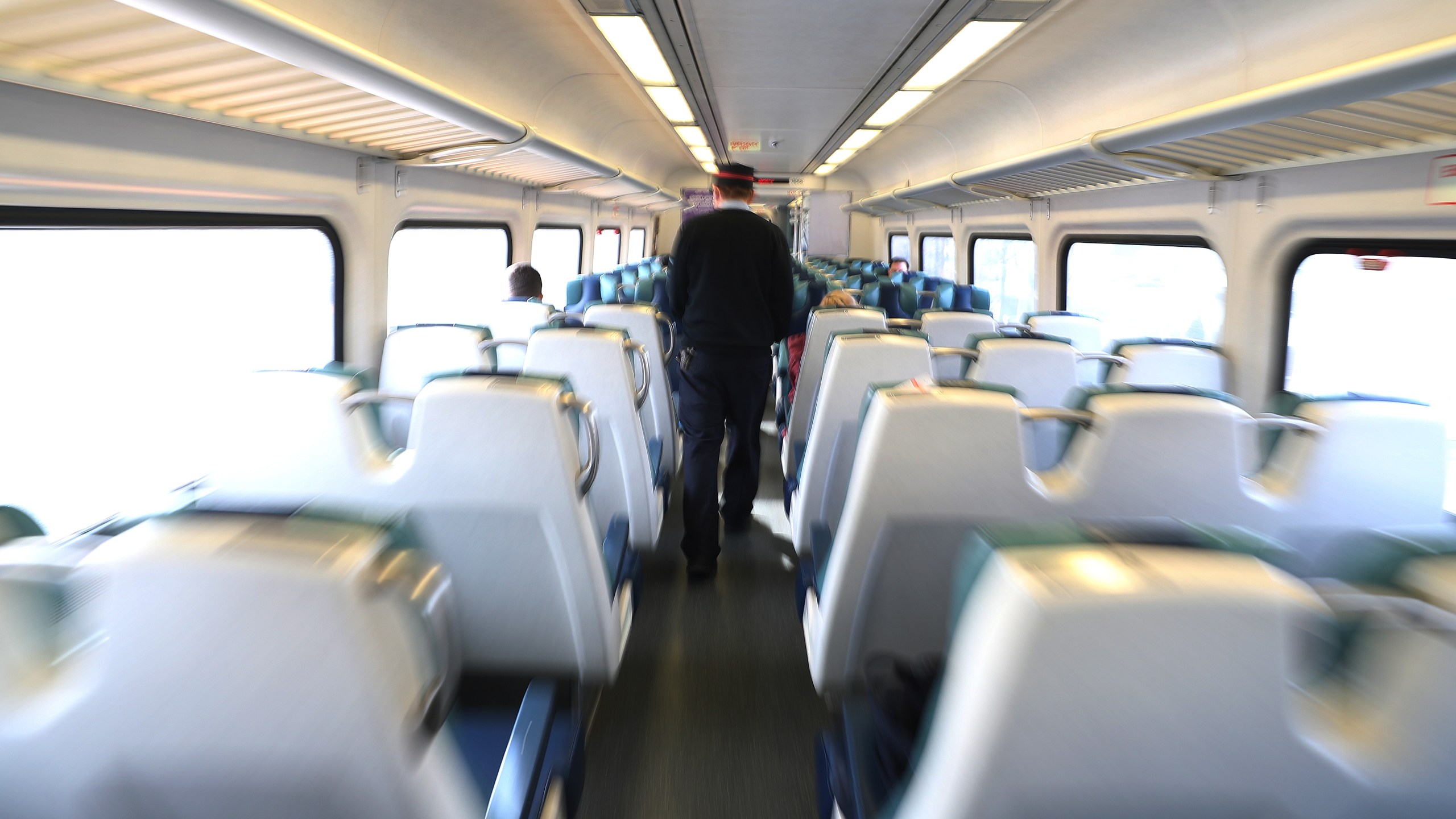 A train conductor walks through a near empty car on the Long Island Railroad on March 18, 2020, in Merrick, New York. (Al Bello/Getty Images)