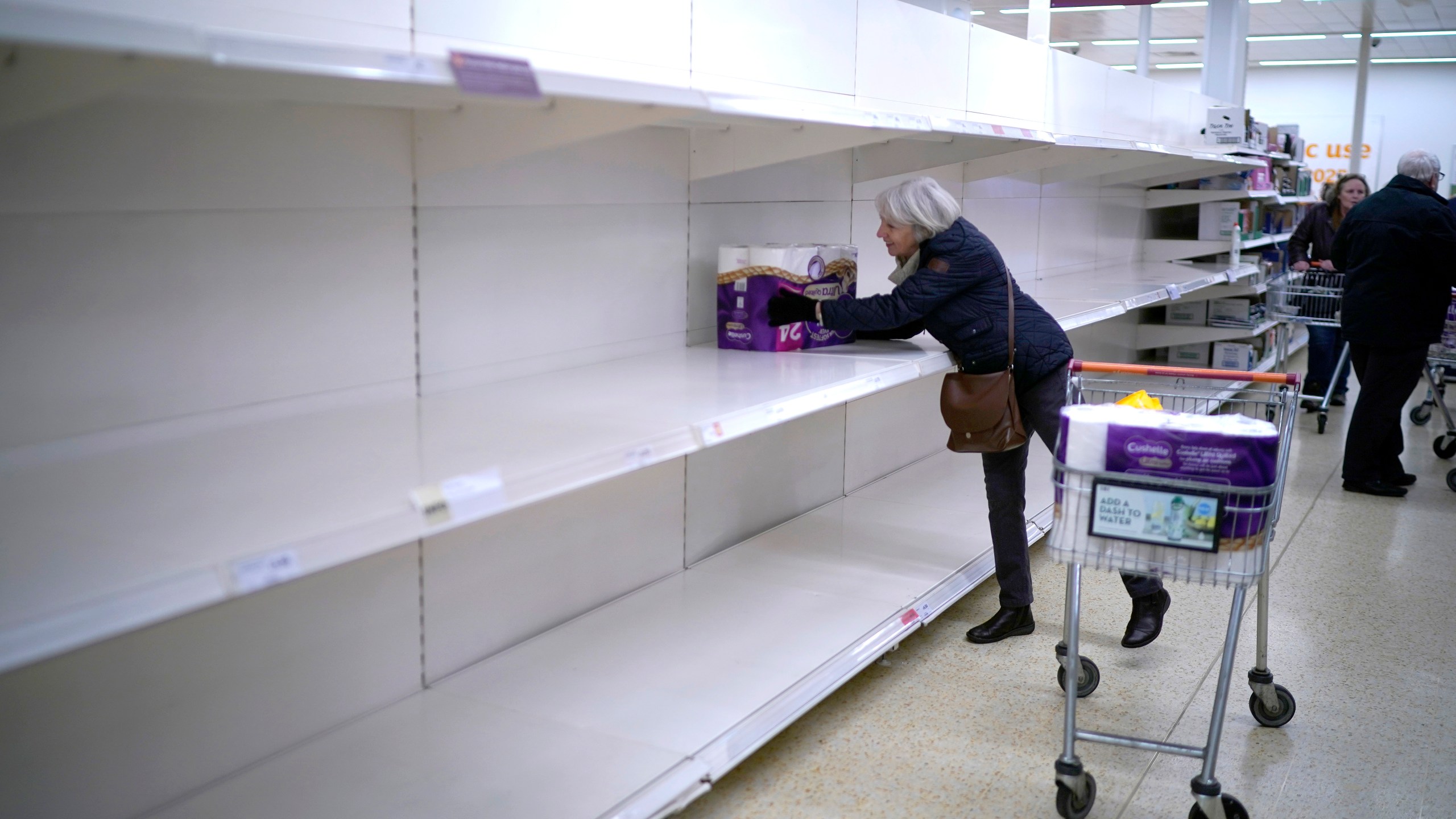 A woman gets the last pack of toilet rolls at Sainsbury's Supermarket on March 19, 2020, in Northwich, United Kingdom. (Christopher Furlong/Getty Images)