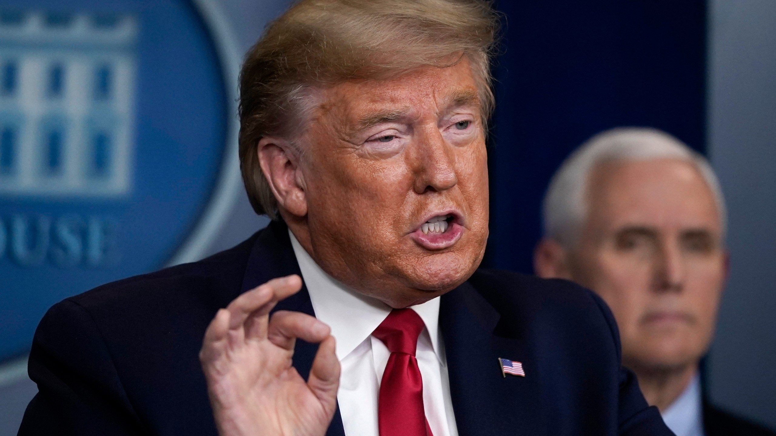 President Donald Trump speaks as Vice President Mike Pence listens during a briefing on the coronavirus pandemic in the press briefing room of the White House on March 26, 2020. (Drew Angerer/Getty Images)