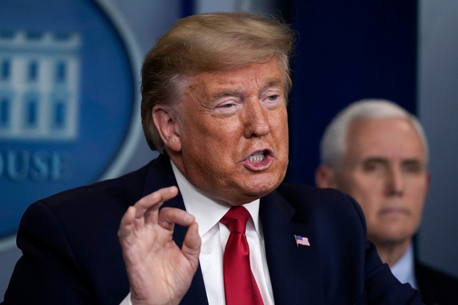 President Donald Trump speaks as Vice President Mike Pence listens during a briefing on the coronavirus pandemic in the press briefing room of the White House on March 26, 2020. (Drew Angerer/Getty Images)