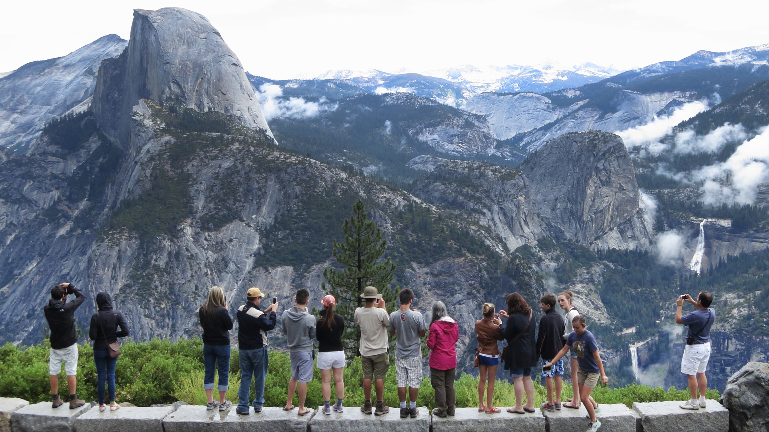 Visitors look out at Yosemite National Park from Glacier Point on July 21, 2014 in Yosemite National Park. (Sean Gallup/Getty Images)