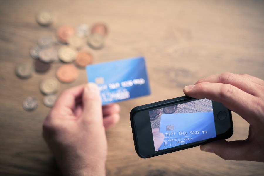 A man photographs a credit card in this undated file photo. (Getty Images)