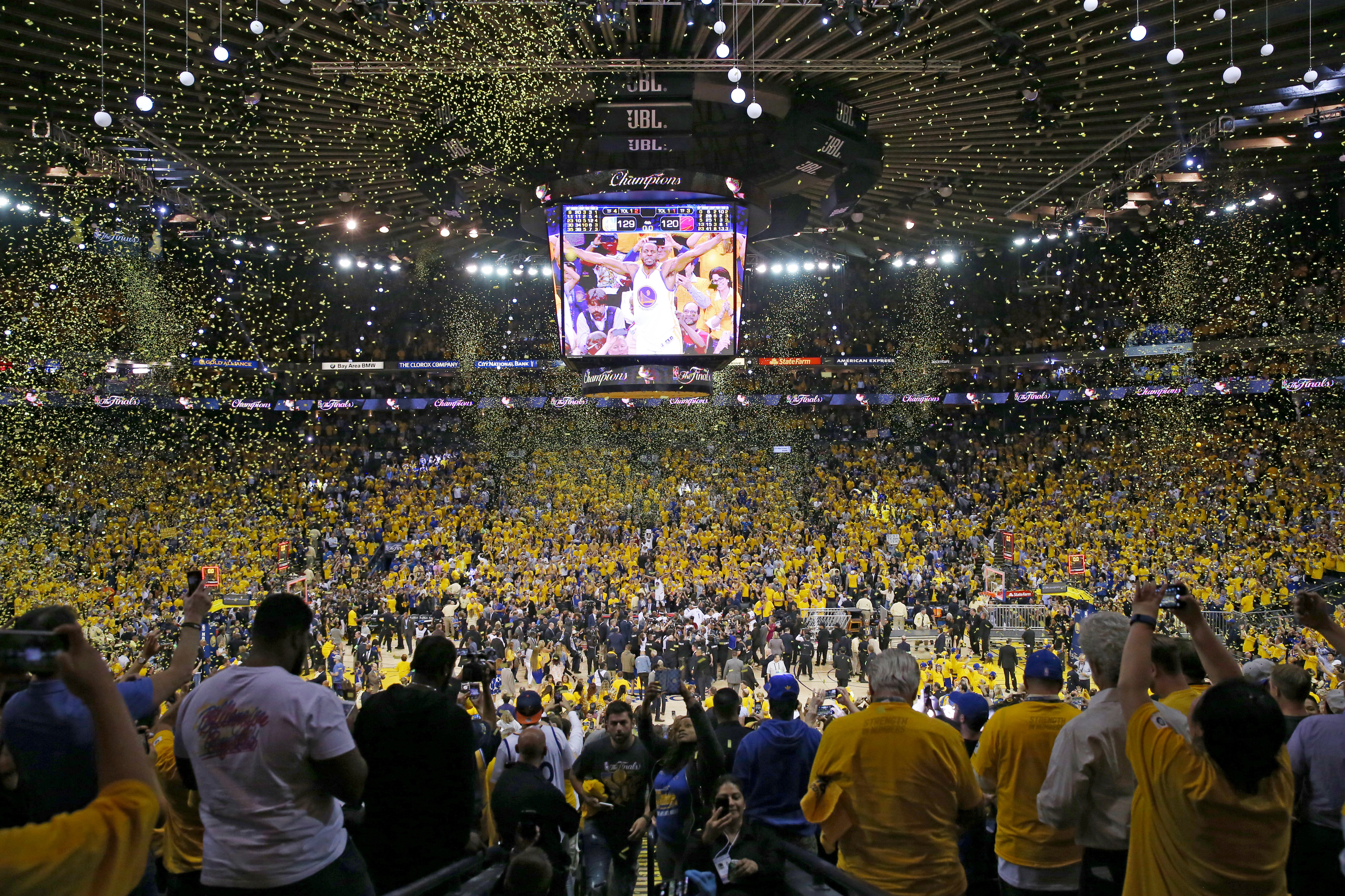 Fans cheer as the Golden State Warriors celebrate after defeating the Cleveland Cavaliers 129-120 in Game 5 to win the 2017 NBA Finals at ORACLE Arena on June 12, 2017, in Oakland, California. ( Ezra Shaw/Getty Images)