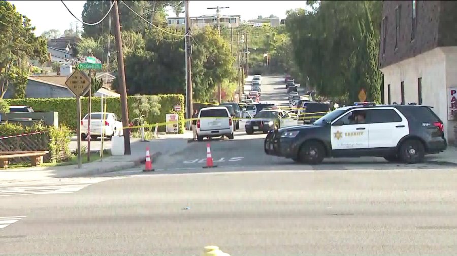 Sheriff's deputies investigate the scene of a shooting that left two boys and a man dead in Lomita on March 29, 2020. (KTLA)