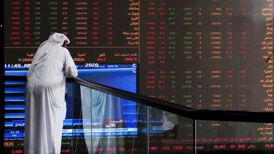 A Kuwaiti trader checks stock prices at Boursa Kuwait in Kuwait City, on March 8, 2020. (Credit: Yasser-Asser Al-Zayyat/AFP/Getty Images)