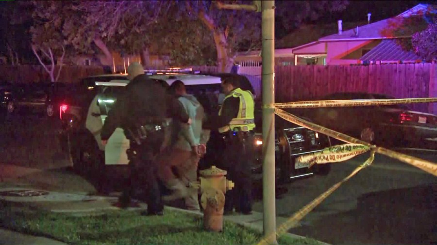 Police take a man into custody in connection with an alleged DUI, hit-and-run crash that left a woman dead in Reseda on March 2, 2020. (Credit: KTLA)