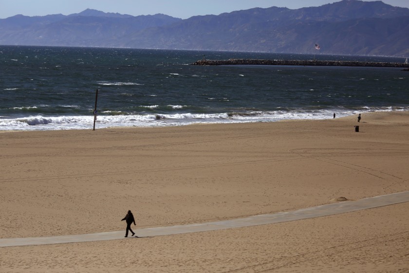 A beach in the Los Angeles area is empty in March 2020 as local officials established restrictions to stem the spread of COVID-19, closing businesses and shutting down trails and beaches throughout L.A. County. (Genaro Molina/Los Angeles Times)