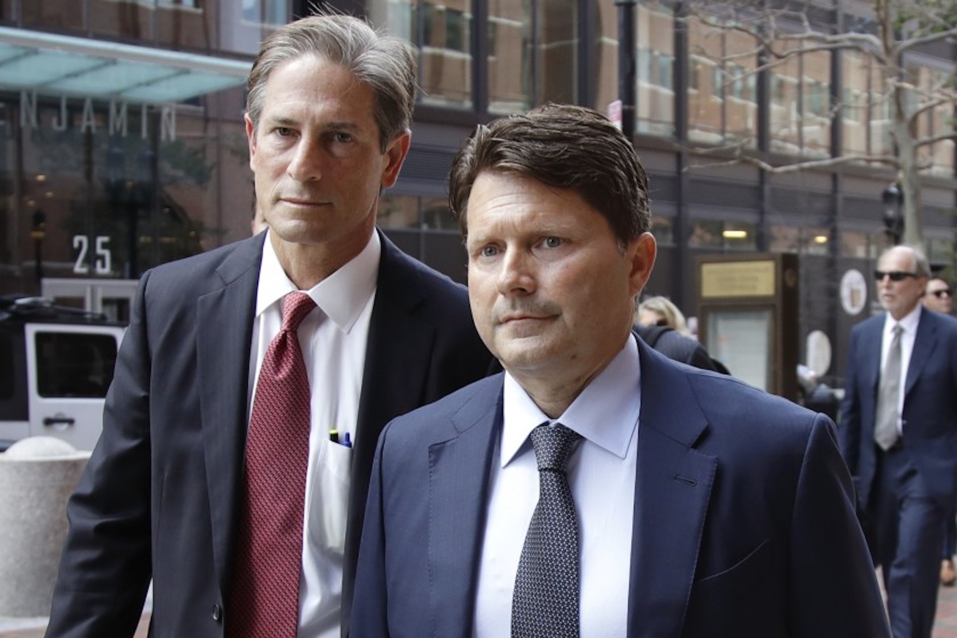 Devin Sloane, right, arrives at federal court in Boston for his sentencing last year. Citing the COVID-19 pandemic, Sloane asked a judge, unsuccessfully, to release him from prison early. (Elise Amendola/Associated Press)