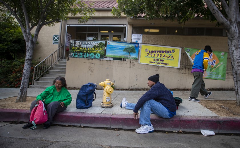 A 53-year-old man waits with other homeless people on March 20, 2020, at the Echo Park Community Center, which is being turned into a shelter because of the coronavirus pandemic. (Allen J. Schaben/Los Angeles Times)