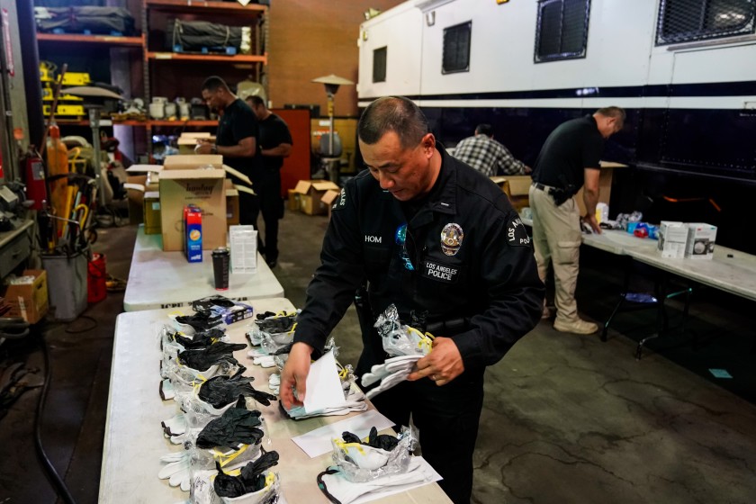 Los Angeles police Lt. Jay Hom helps assemble kits consisting of an N95 mask, work gloves and nitrile gloves on March 11, 2020, for field officers to protect themselves from the coronavirus. (Credit: Kent Nishimura / Los Angeles Times)