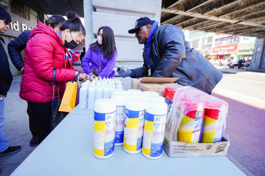 People wear protective masks as they get disinfecting products in this undated photo. (John Nacion/STAR MAX/IPx/AP)