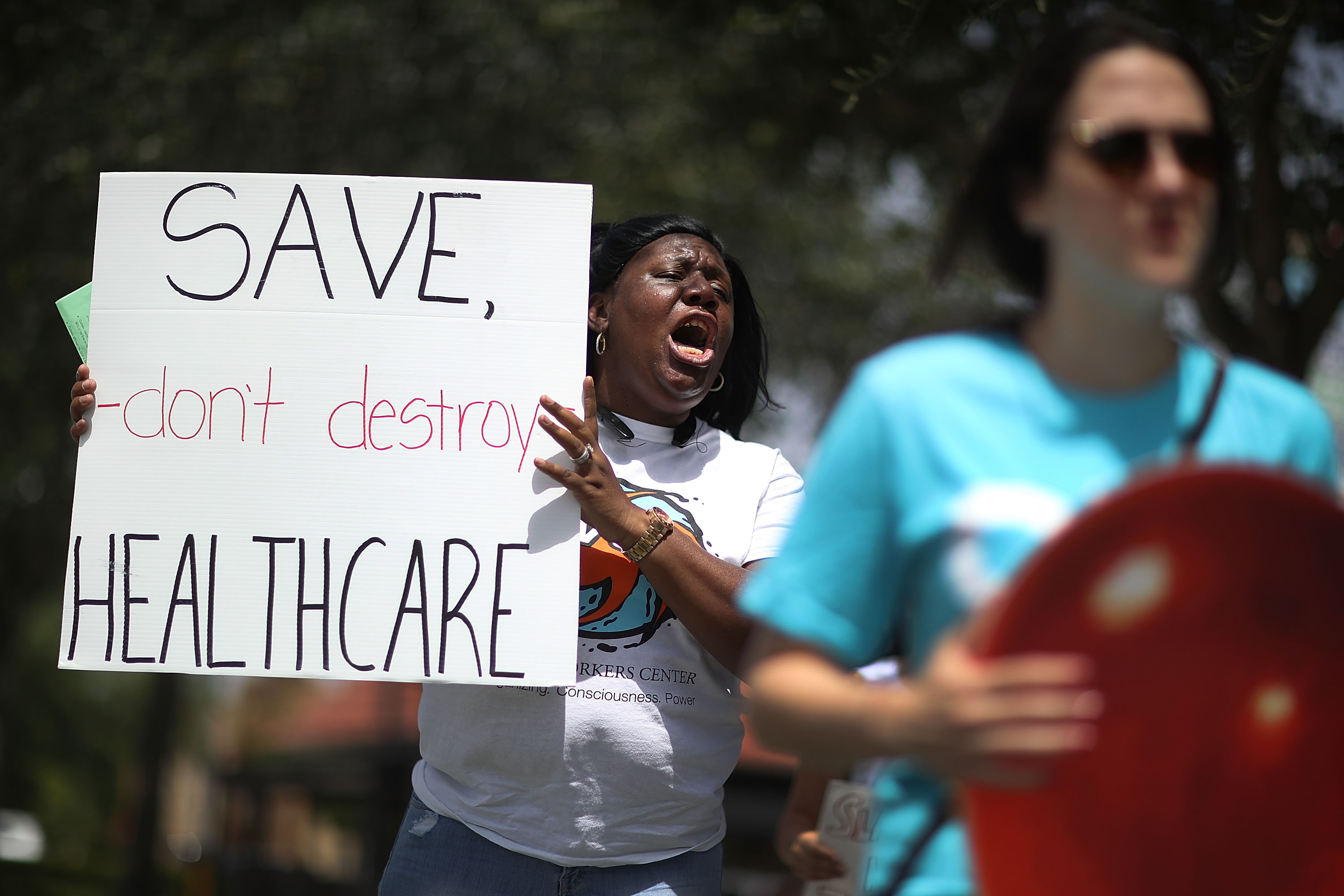 Protesters ask for Rep. Carlos Curbelo to explain his vote on the Affordable Care Act in front of his office on August 3, 2017, in Miami, Florida. (Joe Raedle/Getty Images)