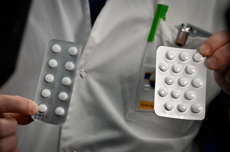 Medical staff shows on February 26, 2020 at the IHU Mediterranee Infection Institute in Marseille, packets of a Nivaquine, tablets containing chloroquine and Plaqueril, tablets containing hydroxychloroquine, drugs that has shown signs of effectiveness against coronavirus. (GERARD JULIEN/AFP via Getty Images)