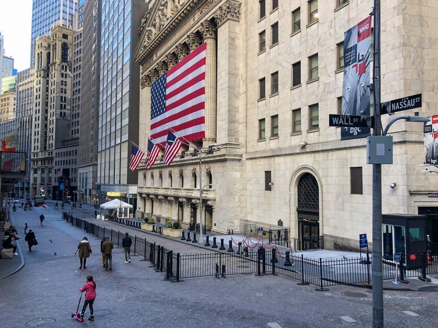 Passersby in front of the New York Stock Exchange. (Samuel Rigelhaupt/Sipa USA/AP)