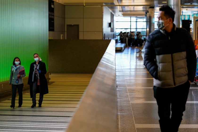 People walk up the ramp, exiting the secure area at the Tom Bradley International Terminal at LAX in this undated photo. (Kent Nishimura/Los Angeles Times)