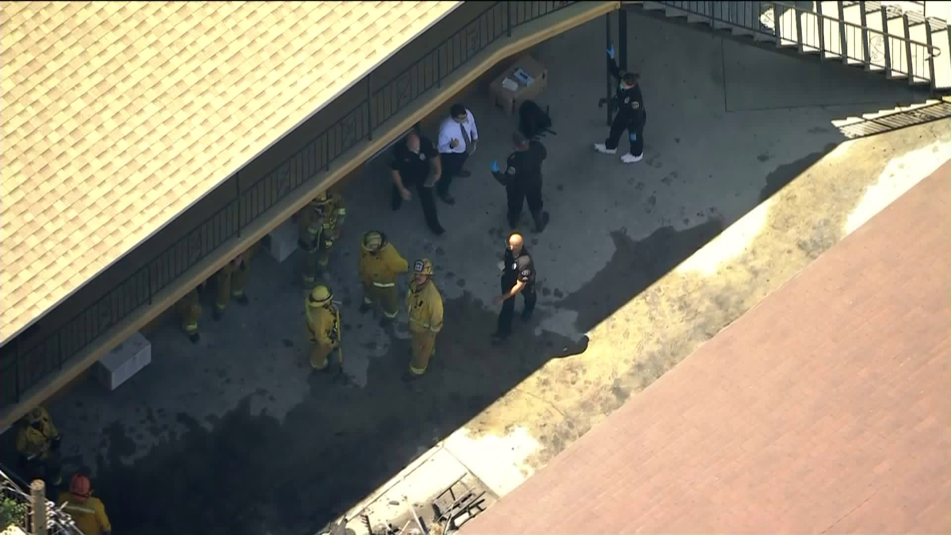 Firefighters work at the scene of a fire that left one girl dead and another gravely injured in Pomona on April 16, 2020. (KTLA)