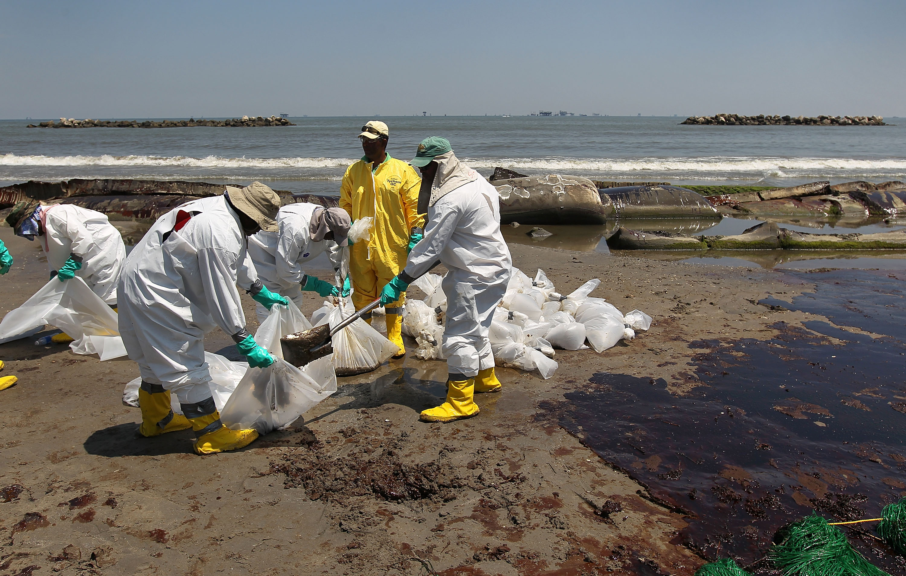 A BP cleanup crew shovels oil from a beach on May 24, 2010 at Port Fourchon, Louisiana. (John Moore/Getty Images)