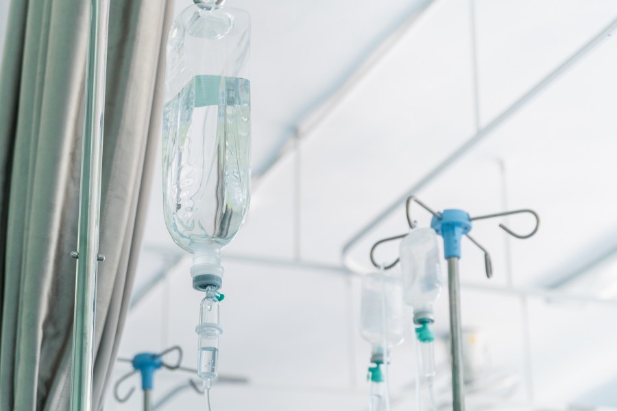 A saline drip hangs from a wall in a hospital room. (Getty Images)