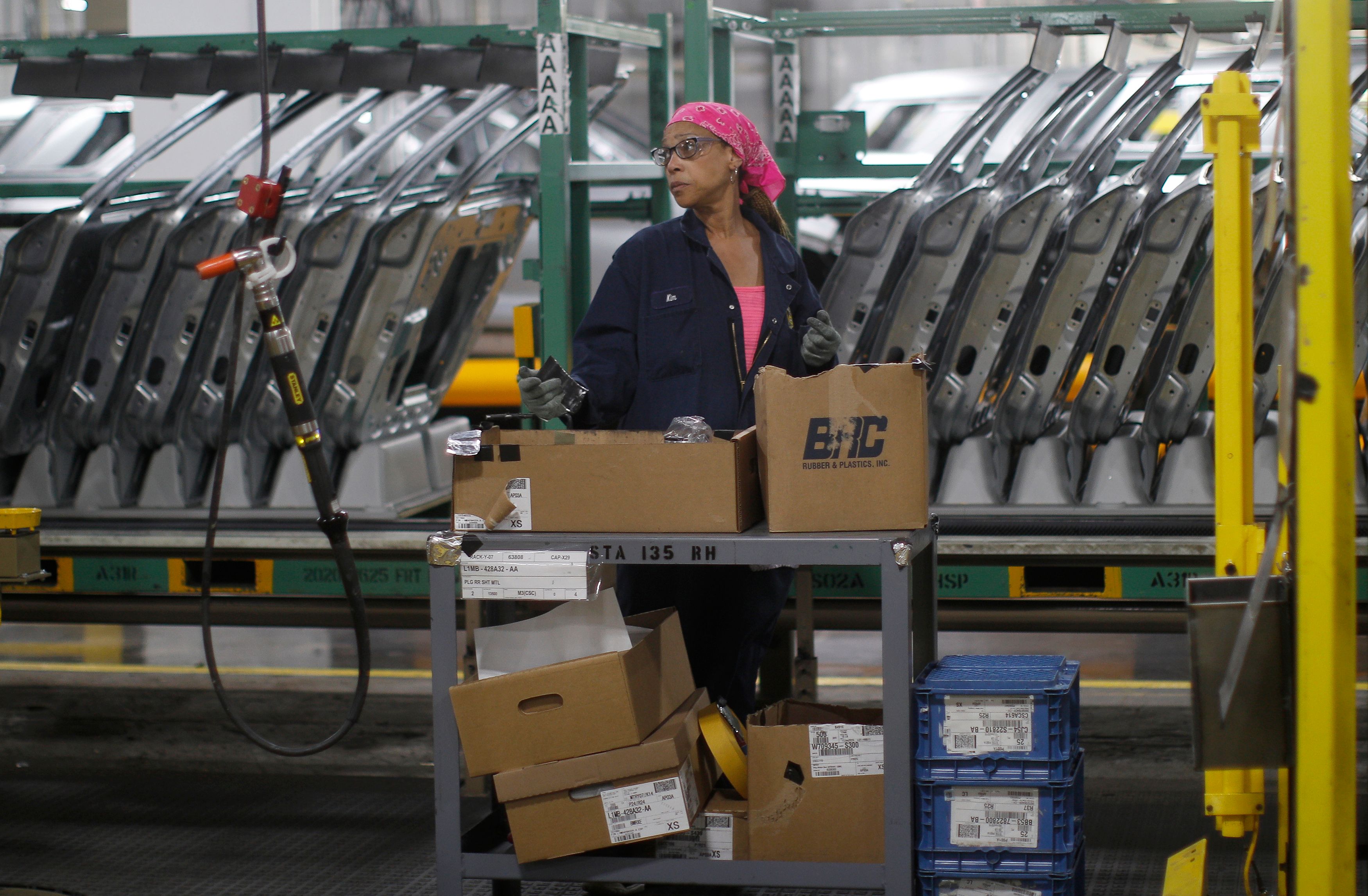 Workers assemble cars at the newly renovated Ford's Assembly Plant in Chicago, June 24, 2019. (JIM YOUNG/AFP via Getty Images)