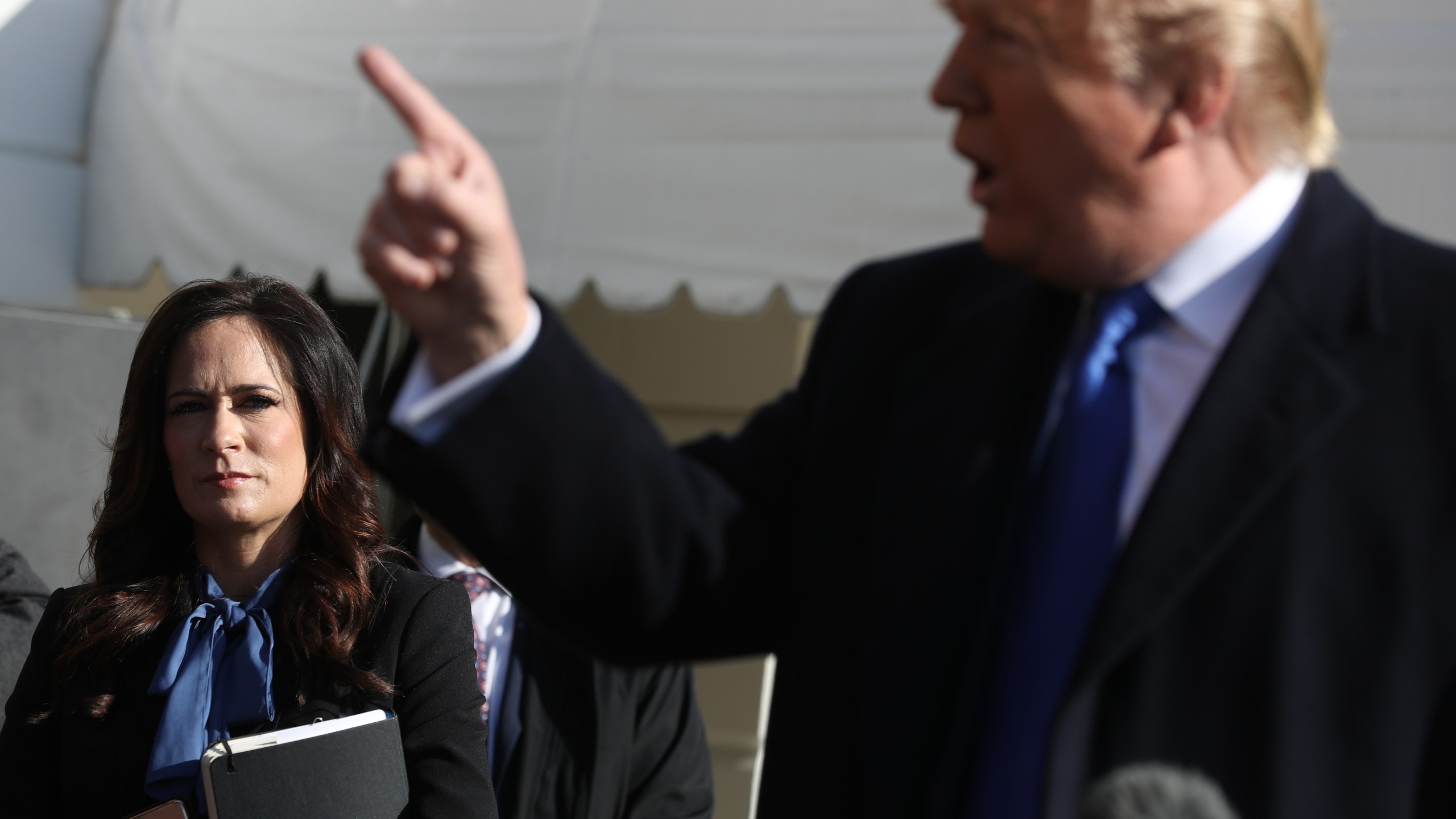 Stephanie Grisham listens as Donald Trump talks to reporters before he boards Marine One and departing the White House on Nov. 8, 2019 in Washington, D.C. (Chip Somodevilla/Getty Images)