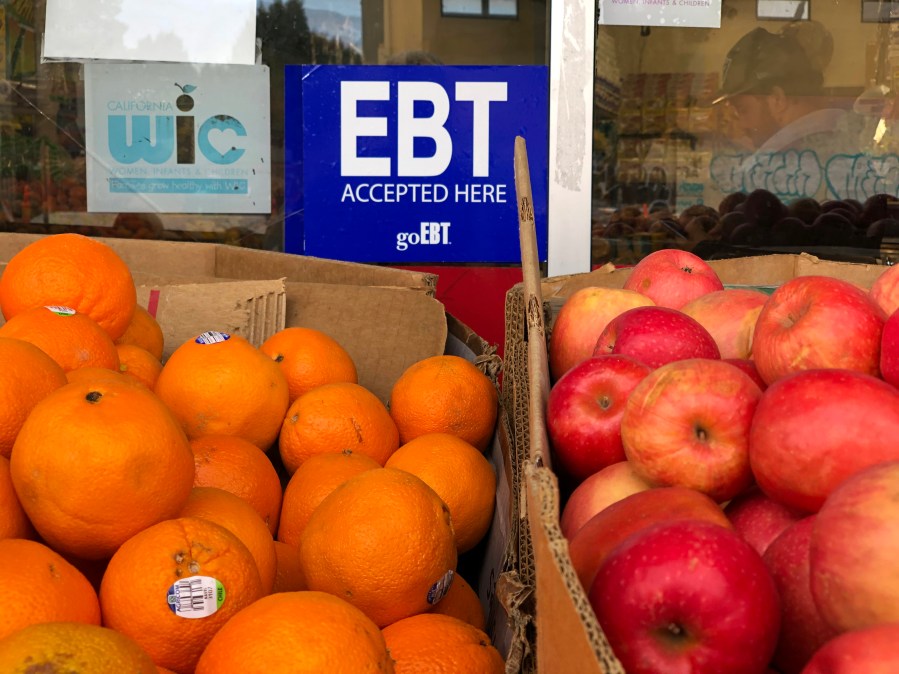 A sign noting the acceptance of electronic benefit transfer (EBT) cards that are used by state welfare departments to issue benefits is displayed at a grocery store on Dec. 4, 2019, in Oakland, Calif. (Justin Sullivan/Getty Images)