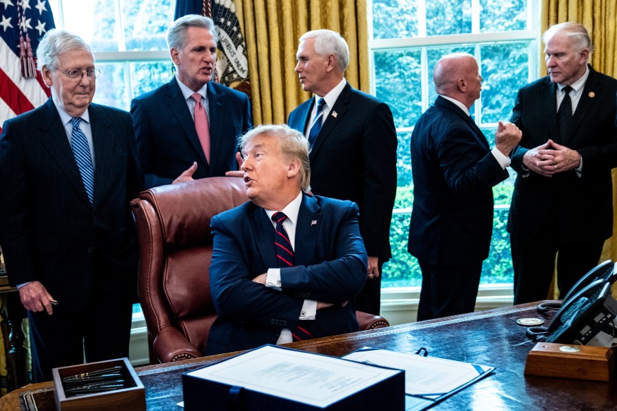 President Donald Trump speaks with Senate Majority Leader Mitch McConnell during a bill signing ceremony for the CARES Act in the Oval Office of the White House on March 27, 2020, in Washington, DC. (Erin Schaff-Pool/Getty Images)