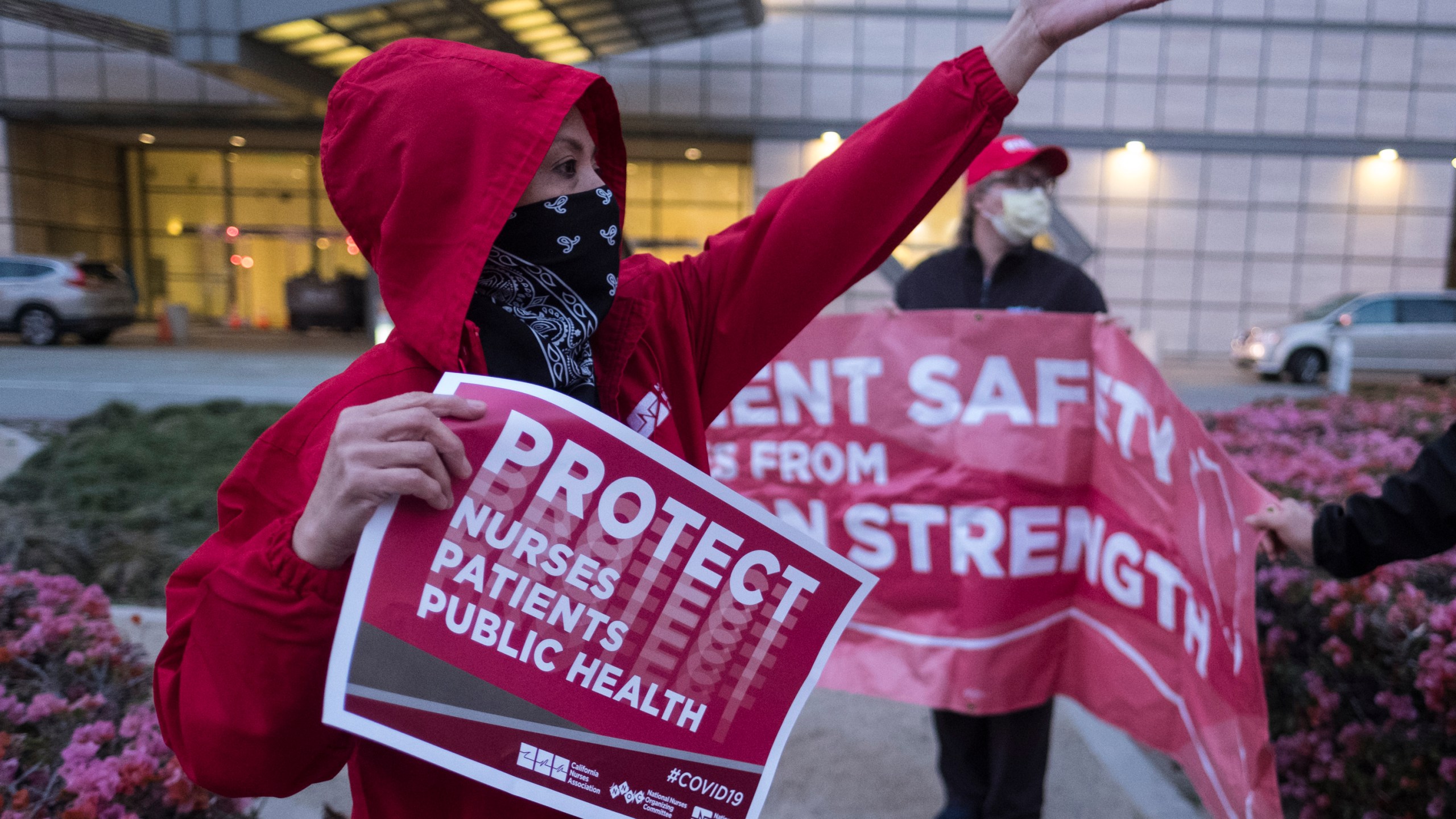 Nurses at UCLA Ronald Reagan Medical Center hold a vigil in Los Angeles on March 30, 2020. (RINGO CHIU/AFP via Getty Images)